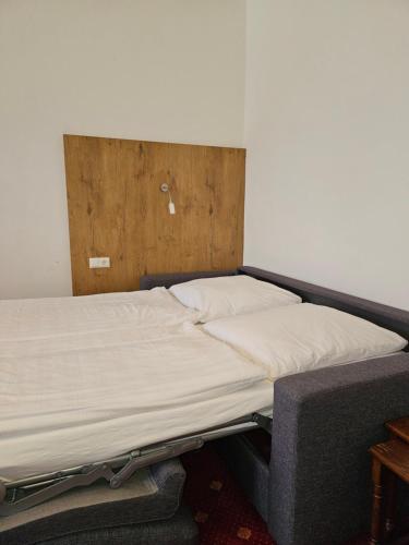 a bed in the corner of a room at Gasthof Klement in Isen