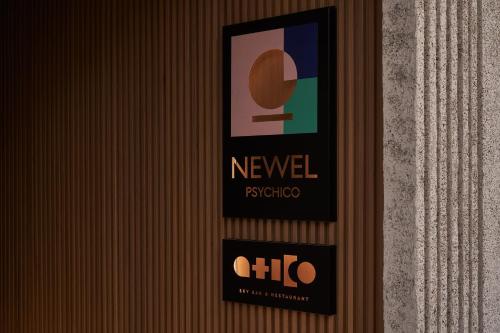 a sign on the wall of a hotel at The Newel Psychiko in Athens