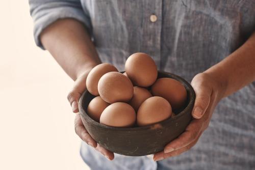 a person holding a black bowl of eggs at The Newel Psychiko in Athens
