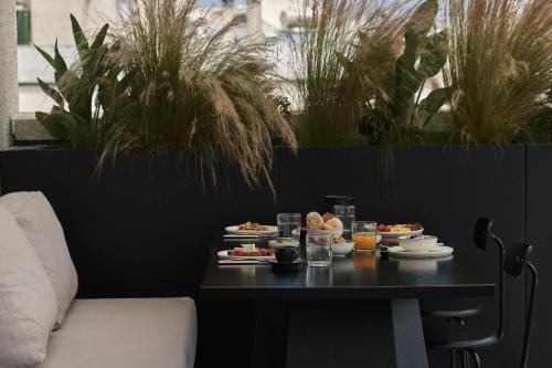 a table with plates of food and drinks on it at The Newel Psychiko in Athens