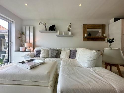 a living room with a couch and a table at Fantastic 2-Bed House with Parking - Hosted by Hutch Lifestyle in Leamington Spa