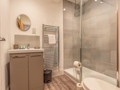 a bathroom with a shower and a sink and a tub at Pass the Keys Stunning Apartment with Terrace in Telford