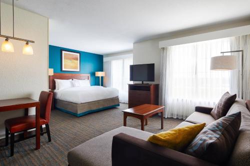 a hotel room with a bed and a living room at Residence Inn by Marriott Killeen in Killeen