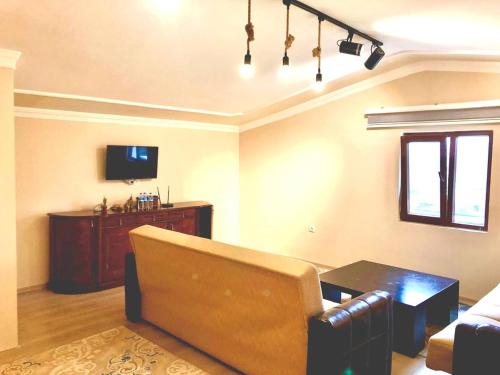 a living room with a couch and a tv at Yalova Halic apartment in Yalova