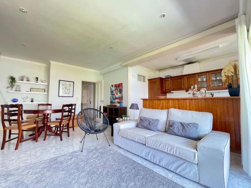 a living room with a white couch and a table at Apartamento Ofir in Fão