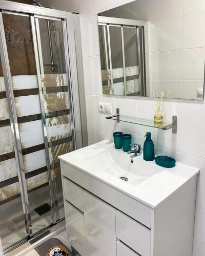 a white bathroom with a sink and a shower at Your Perfectt place in Valencia