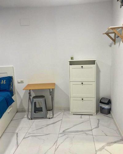a bedroom with a bed and a desk and a drawer at Your Perfectt place in Valencia