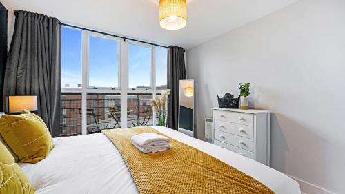 a bedroom with a bed and a large window at Host & Stay - Knowledge Quarter Apartment in Liverpool