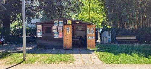 a small woodenshed with a bench in a park at La Rosa e la Spina - Casa Vacanze indipendente con giardino privato - Dervio, Lago di Como in Dervio