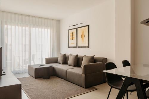 a living room with a couch and a table at Europa Apartments in Hospitalet de Llobregat
