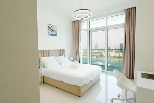 a bedroom with a bed and a large window at Exquisite 2BR in Sunrise bay at Emaar Beachfront in Dubai