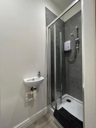 a bathroom with a sink and a shower at Studio Apartment Great Location in Swadlincote