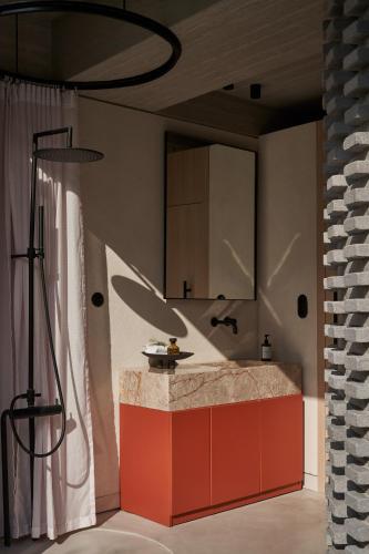 a kitchen with a red counter and a sink at The Newel Psychiko in Athens