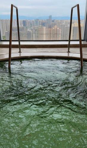 a swimming pool in a building with a view of a city at JW Marriott Hotel Xi'an in Xi'an