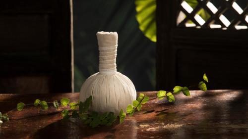 a white vase sitting on top of a table at Rhythm Kumarakom in Kumarakom