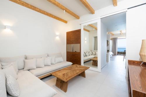 a living room with a white couch and a table at Rigas Boutique Hotel & Spa in Afitos