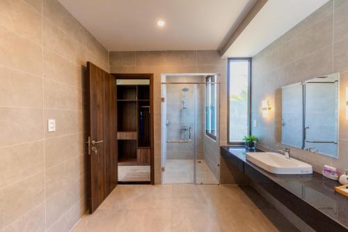 a bathroom with a sink and a shower at Emerald Garden Retreat in Phú Quốc