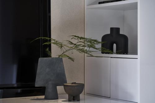 a room with a vase and a plant on a counter at The Newel Psychiko in Athens
