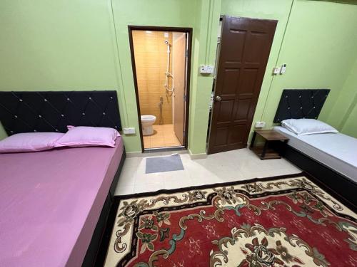 Ένα ή περισσότερα κρεβάτια σε δωμάτιο στο Homestay IJAA