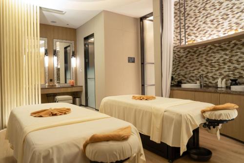 a bathroom with two beds with towels on them at JW Marriott Hotel Xi'an in Xi'an