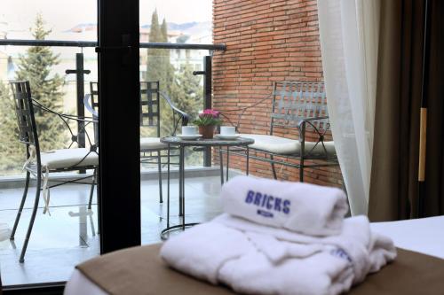 a pillow sitting on a table in front of a balcony at Bricks Hotel in Tbilisi City