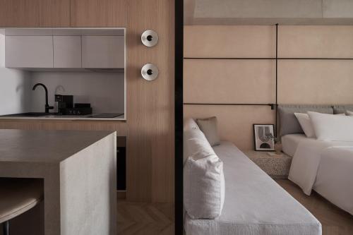 a kitchen and a living room with a bed in a room at The Newel Psychiko in Athens