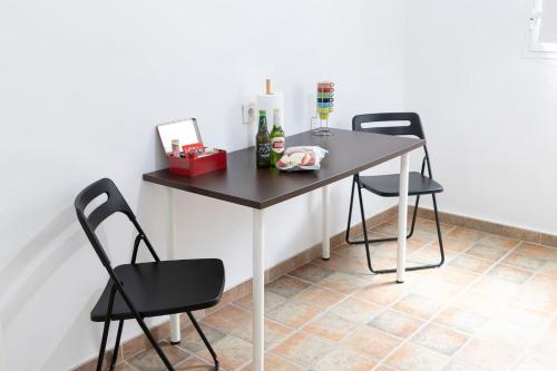 a table with two chairs and two bottles of wine at La Monimba in Las Lagunas