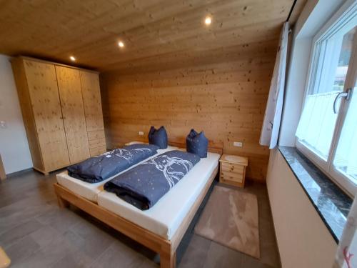 a bedroom with a bed in a room with a window at Rovina Apartments in Gaschurn