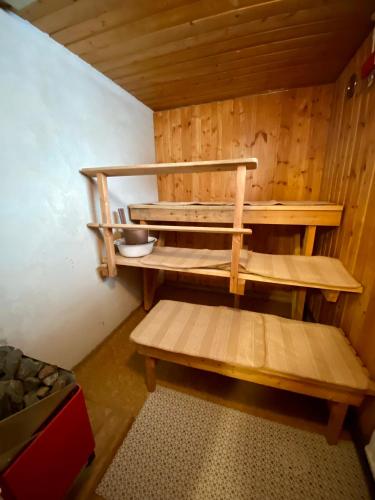 a wooden sauna with a wooden bench in a room at Villa Nisula - yläkerran asunto in Teuva