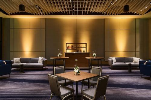 a lobby of a hotel with tables and couches at JW Marriott Dallas Arts District in Dallas
