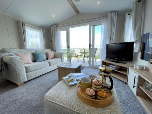 Una televisión o centro de entretenimiento en Pass the Keys Gorgeous Kippford Home With Outstanding Views