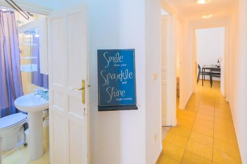 a bathroom with a sign that reads smile for a sponge bite at For You Rentals Encantadora vivienda de 3 habitaciones en Madrid AME49 in Madrid