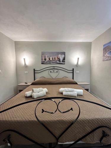 a bedroom with a large bed with two towels on it at Case Vacanze Seggettieri in Palermo