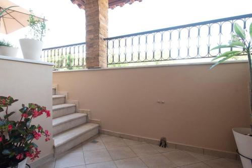 a staircase in a house with a cat sitting on the floor at Coast Horizon in Romanós