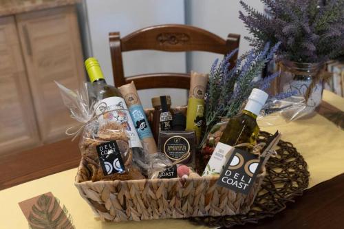 a basket filled with bottles of wine on a table at Coast Horizon in Romanós