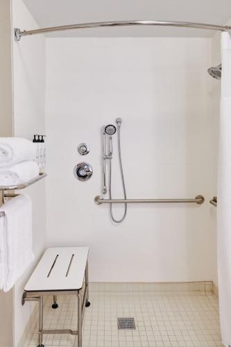 a white bathroom with a shower and a sink at SpringHill Suites Phoenix Tempe Airport in Tempe