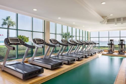 a row of treadmills and ellipticals in a gym at Sheraton Grand Doha Resort & Convention Hotel in Doha