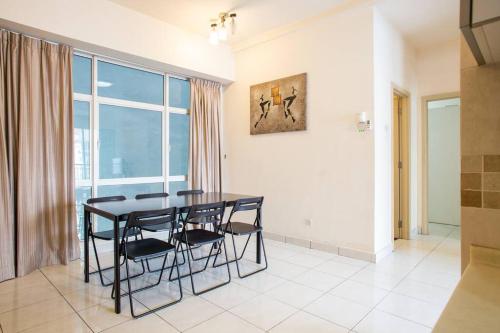 a dining room with a table and chairs and a window at Cosy 2Bed2Bathroom at Casa Suites in Petaling Jaya