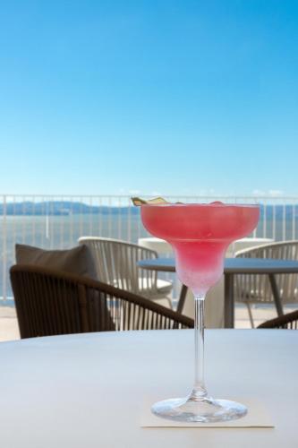a martini glass sitting on a table on the beach at Upon Vila - Alcochete Hotel in Alcochete