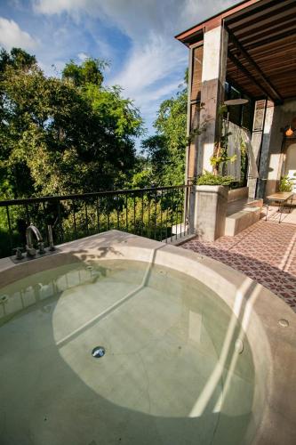 a small swimming pool in front of a house at Proud Phu Fah Maerim Resort in Mae Rim