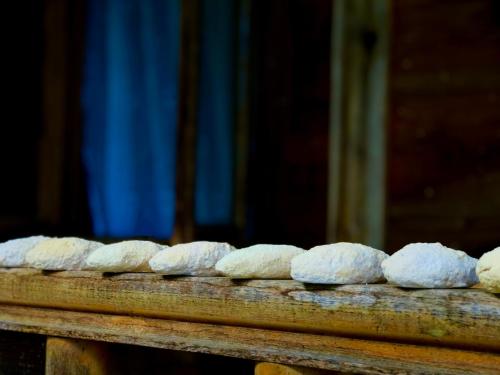 a group of loaves of bread on a wooden table at Zesopheli guest house in Keda Agro & Eco tourism in Zesop'eli
