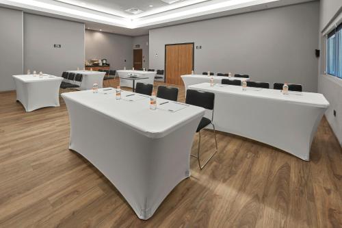 a conference room with white tables and chairs at City Express Plus by Marriott Ciudad de Mexico Interlomas in Mexico City