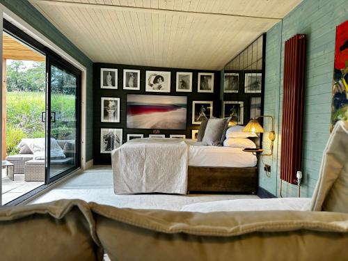 a bedroom with a bed and a couch at Peak District Romantic Retreat Outdoor Japanese Whirlpool bath in Stanton in Peak