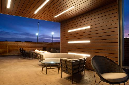 a patio with a couch and chairs and a table at Courtyard Kansas City Olathe in Olathe