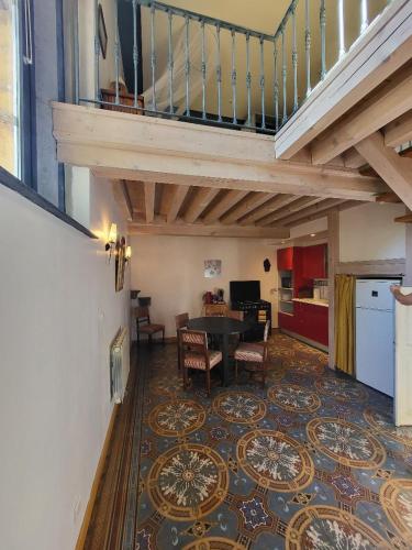 un salon avec une table et un escalier dans l'établissement Atypique Chapelle aménagée, à Albigny-sur-Saone