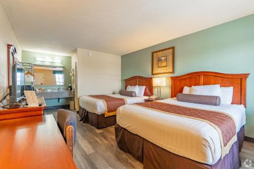 a hotel room with two beds and a flat screen tv at Key West Inn - Tunica Resort in Tunica Resorts