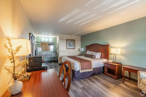 a hotel room with a bed and a television at Key West Inn - Tunica Resort in Tunica Resorts