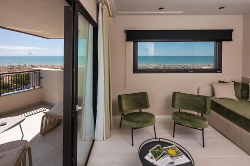 a room with a balcony with a view of the ocean at Savoy Beach Hotel & Thermal Spa in Bibione