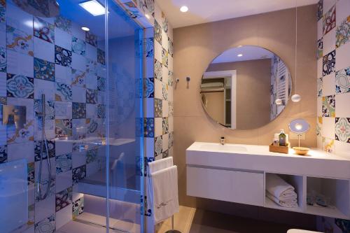 a bathroom with a sink and a mirror at Savoy Beach Hotel & Thermal Spa in Bibione