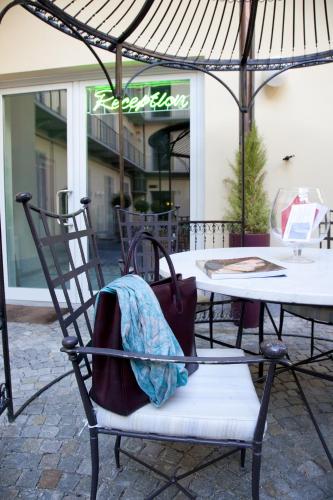 a bag sitting on a chair in front of a table at Santa Giulia Hotel e Residence Torino in Turin